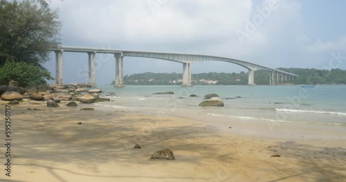 Side view of the bridge connecting Sihanoukville to Koh Puos island from the sand beach photo
