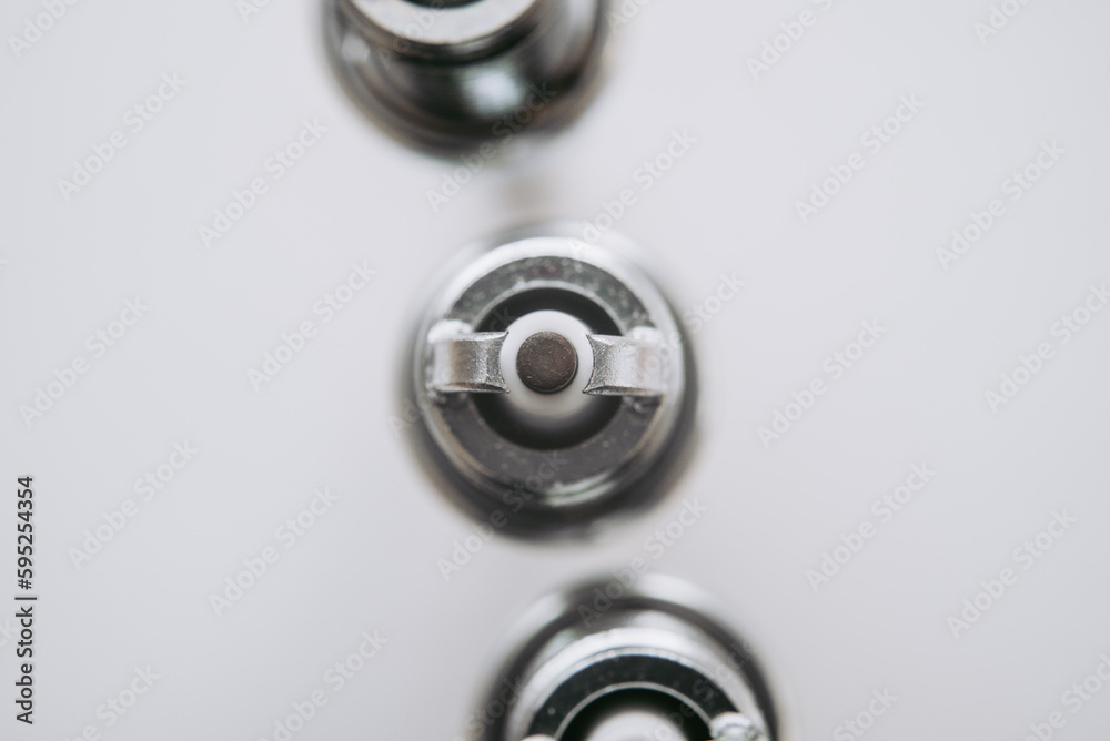 Car service. A set of new car spark plugs as a spare part of motor vehicles on white. Group of candles for the motor close-up