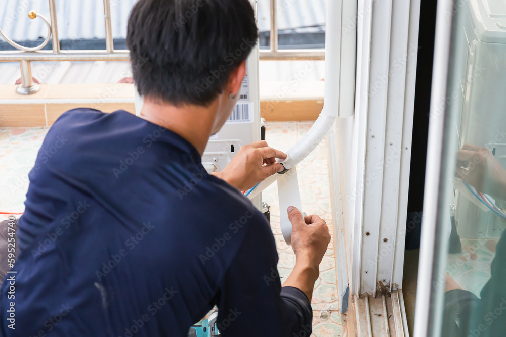 Air conditioning technicians install new air conditioners in homes, Repairman fix air conditioning systems, Male technician service for repair and maintenance of air conditioners