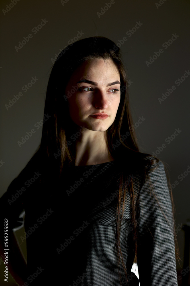 Beautiful girl in stylish clothes. Black dress, studio shot. The model poses in front of the camera. A student in a photo studio. Young beautiful girl Beautiful girl in stylish clothes. Black dress, studio shot. The model poses in front of the camera. A student in a photo studio. Young beautiful girl
