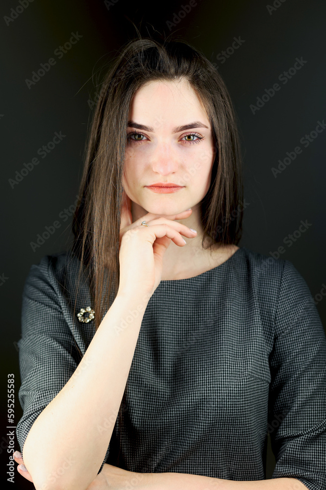 Beautiful girl in stylish clothes. Black dress, studio shot. The model poses in front of the camera. A student in a photo studio. Young beautiful girl Beautiful girl in stylish clothes. Black dress, studio shot. The model poses in front of the camera. A student in a photo studio. Young beautiful girl