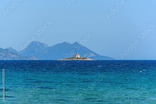 Lighthouse on a small island near Korcula island in Adriatic sea in Croatia on sunny day © Marko Klarić/Wirestock Creators