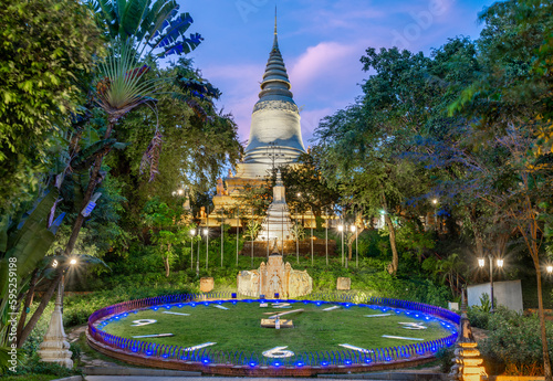 The illuminated pagoda of Wat Phnom Daun Penh Buddhist temple at sunset,Phnom Penh,Cambodia. photo