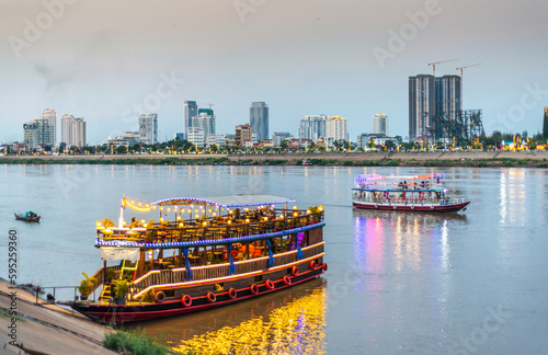 Foto Tourist river cruise boats,lit up at dusk,await customers,Phnom Penh,Cambodia