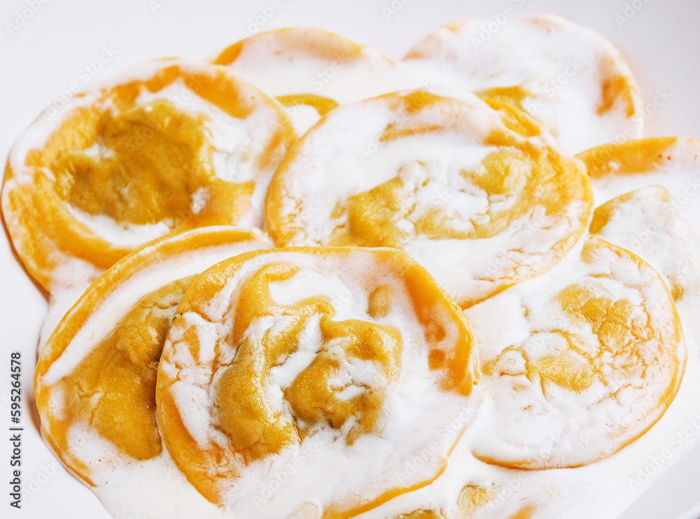 Boiled ravioli with sour cream on plate Boiled ravioli with sour cream on plate