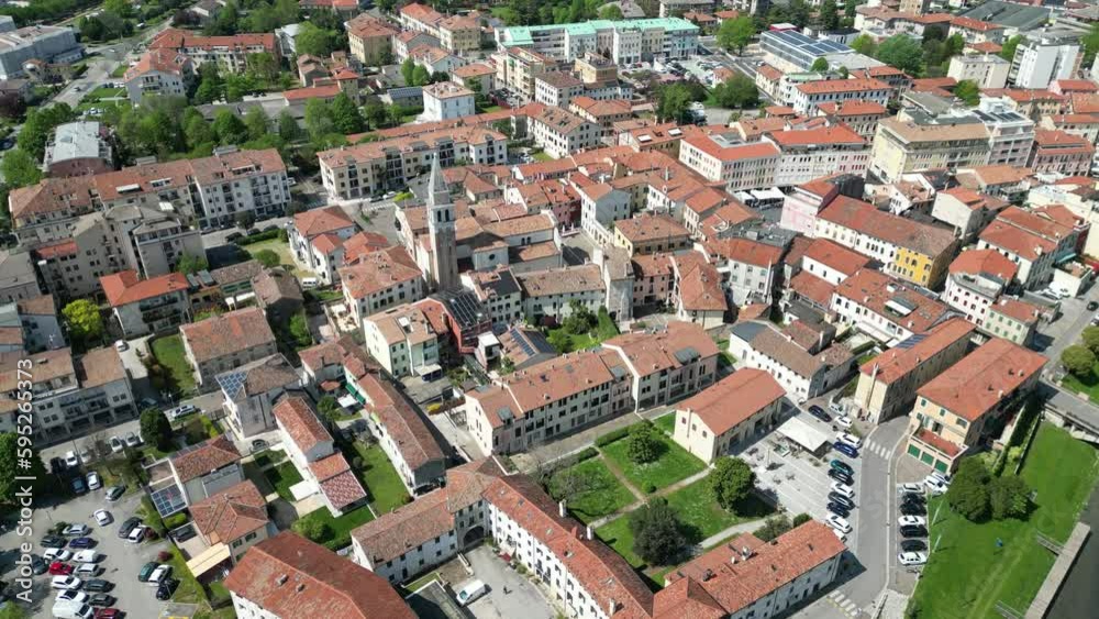 Aerial shot of a small Venetian city. Red roofs, late spring and a river in sight. Aerial shot of a small Venetian city. Red roofs, late spring and a river in sight.