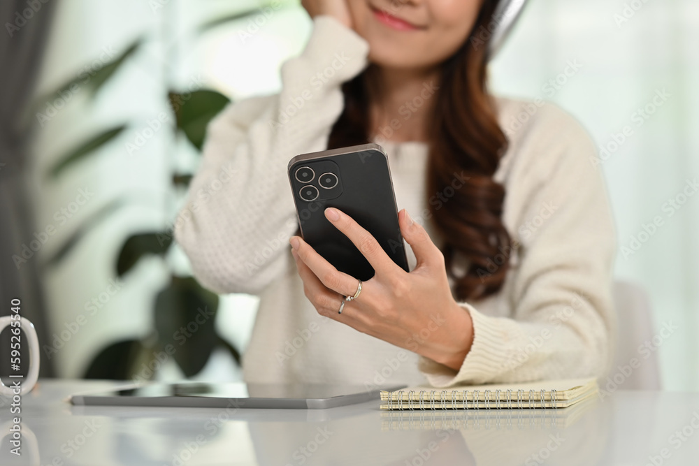 Selective focus on hand, woman checking social media or chatting with friends on mobile phone Selective focus on hand, woman checking social media or chatting with friends on mobile phone