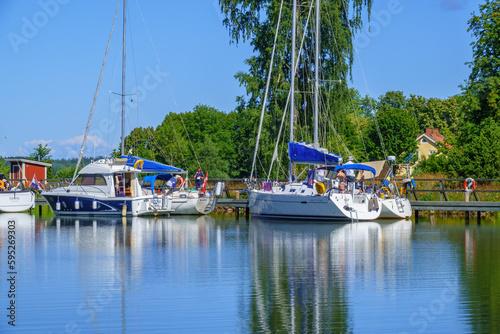 Pleasure boats lying on a bridge on a beautiful summer day at Gota canal in Swed Fototapet