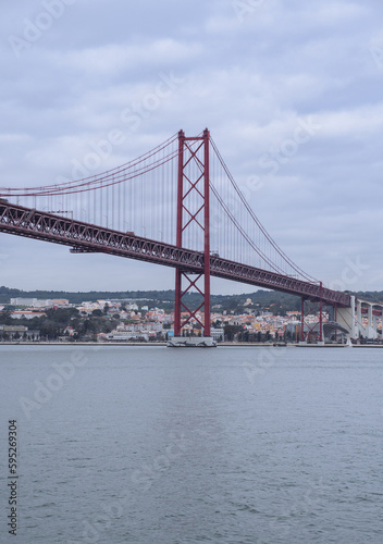 View of the 25 April bridge from the Tagus river in Lisbon  Portugal . Europe s longest bridge connecting the city of Lisbon.