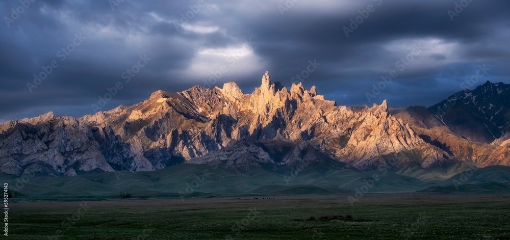 Beautiful mountain landscape of Kazakhstan. Pointed stone peaks of mountains against the backdrop of stormy sky.