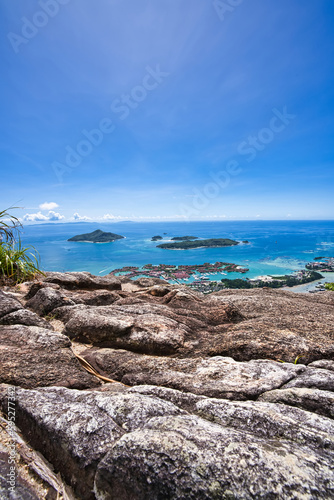 opolia trail, view over granite rock of eden island,, St anne marine park, praslin and la digue.