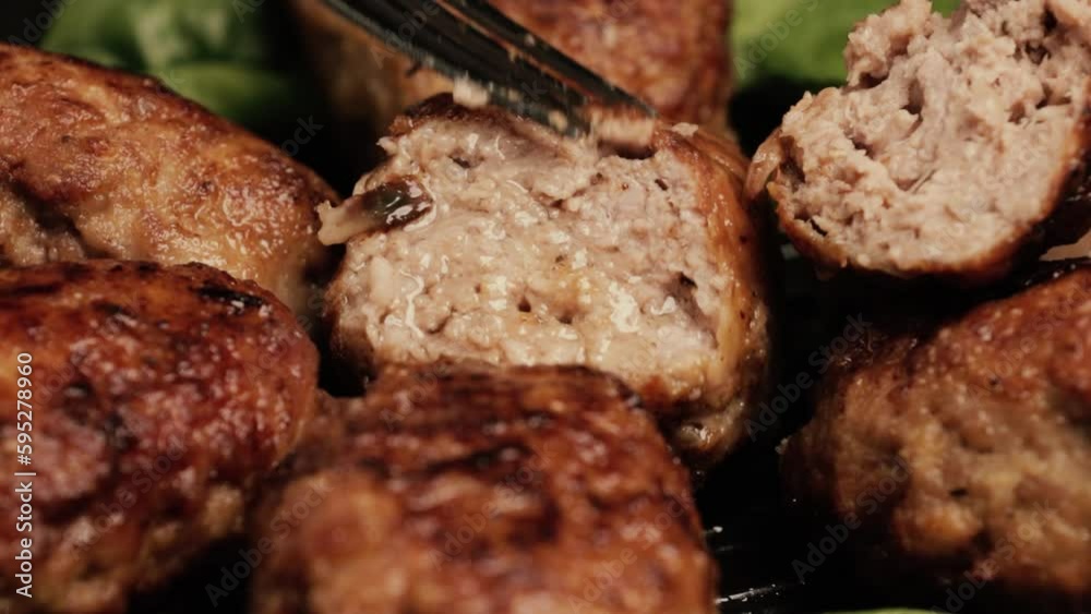 Pork, beef or chicken minced meat cutlets. The cook shows how juicy the cutlets are. Pan-fried meatballs.