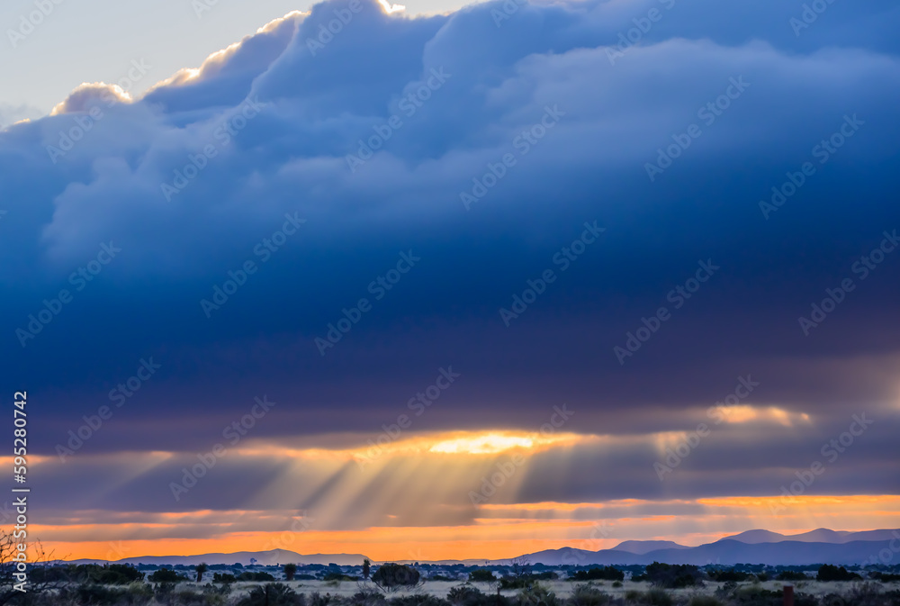 Silver Lining cloud with sunrise over desert 