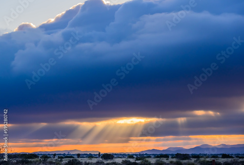 Silver Lining cloud with sunrise over desert 