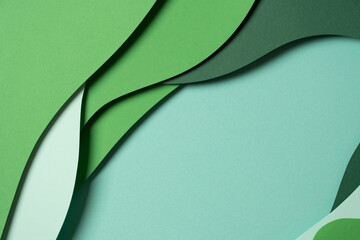 Abstract green color paper texture background. Minimal paper cut style composition with layers of geometric shapes and lines in green tone shades. Top view