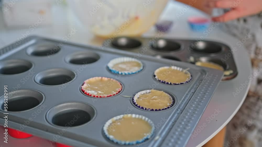 Caucasian Girl Making Delcious Muffin Cup Cakes Creating Mess in Kitchen Caucasian Girl Making Delcious Muffin Cup Cakes Creating Mess in Kitchen