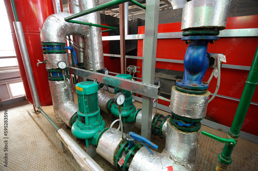 Complex system of pumps , manometers, pipelines, faucets and valves. Production hall of the biggest in Ukraine boiler-house using wood chips. Complex system of pumps , manometers, pipelines, faucets and valves. Production hall of the biggest in Ukraine boiler-house using wood chips.