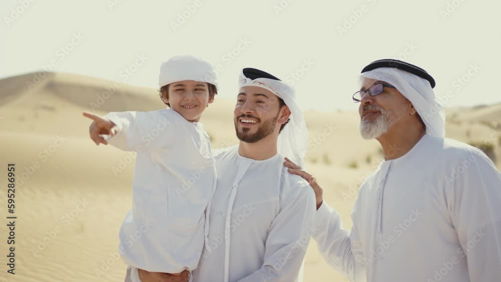 Three generation family spending time in the desert making a safari in Dubai. Concept about middle eastern cultures and lifestyle in the emirates Three generation family spending time in the desert making a safari in Dubai. Concept about middle eastern cultures and lifestyle in the emirates