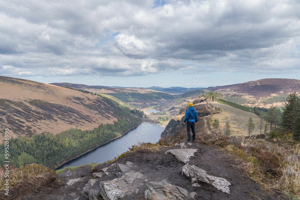Beautiful shot of a hiker on the Spinc trail in the Glendalough Wicklow Mountains