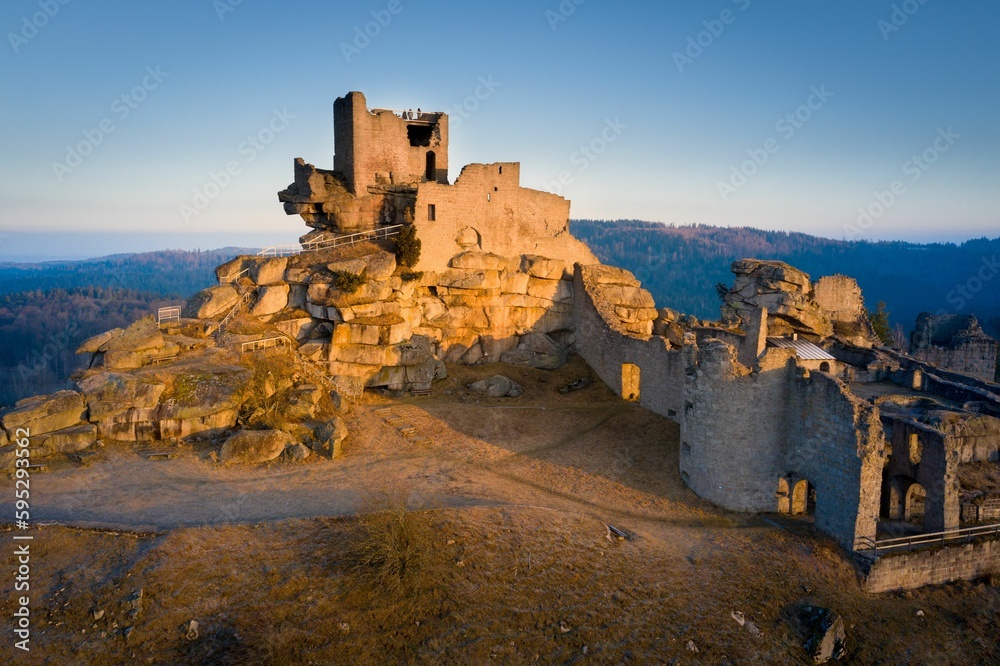 an old castle is perched on a rocky hill overlooking the mountains