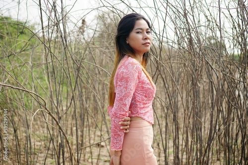 Beautiful woman standing in the forest
