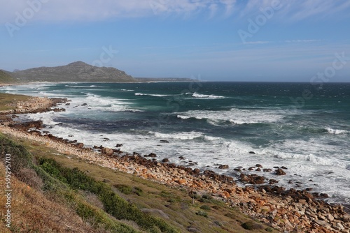 Breathtaking view of a turquoise-hued ocean, with rocks on the shoreline. Cape of Good Hope.