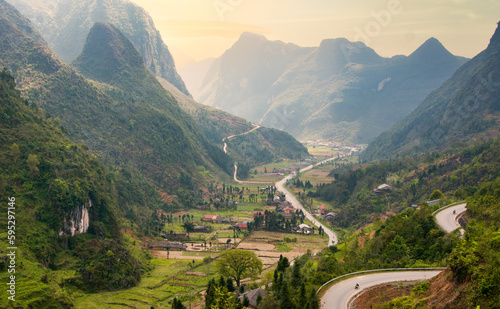 Winding Road Through Green Mountains at Sunset