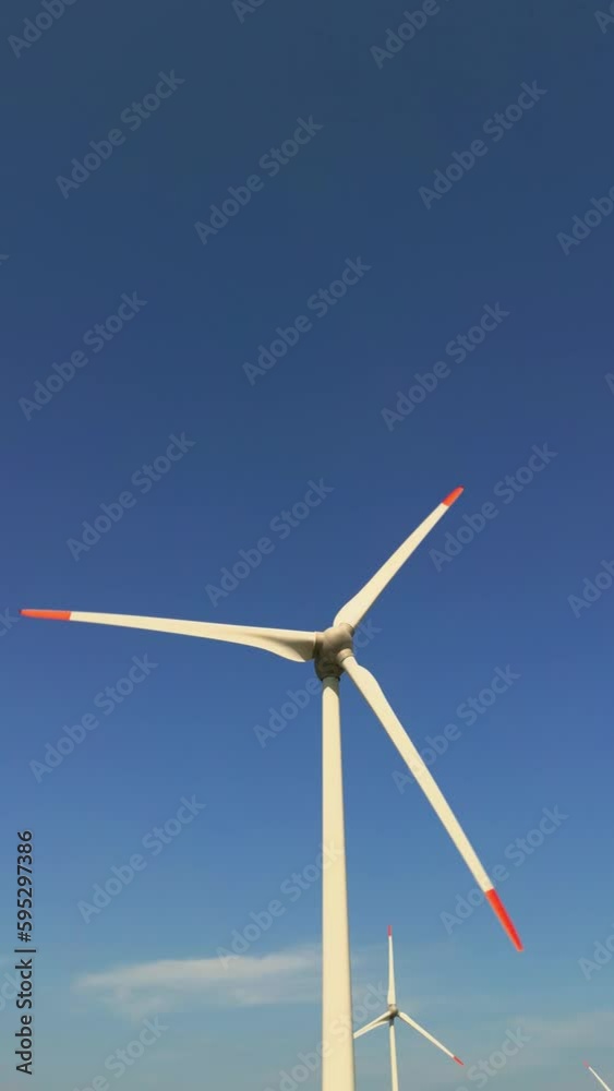 Aerial view of windmills farm for energy production on beautiful cloudy sky at highland. Wind power turbines generating clean renewable energy for sustainable development. High quality 4k footage Aerial view of windmills farm for energy production on beautiful cloudy sky at highland. Wind power turbines generating clean renewable energy for sustainable development. High quality 4k footage