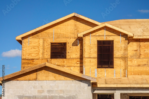 Window openings in unfinished exterior walls of single-family suburban house under construction in southwest Florida