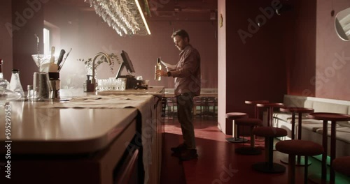 Male manager doing stocktaking in modern bar