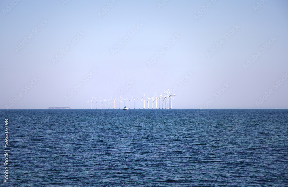 Wind turbine farm power genarator in beautiful nature landscape for production of renewable green energy.