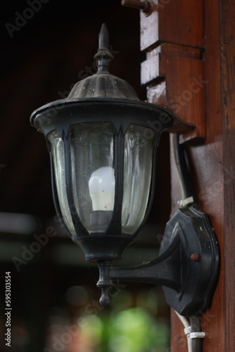 antique lamp on wooden wall