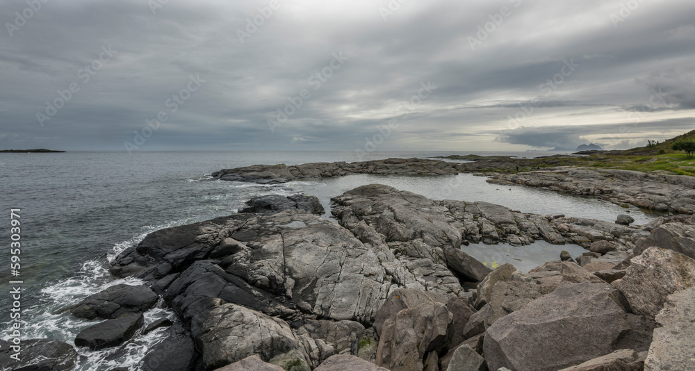 View of rocky shoreline with alot of clouds and rainy weather on Lofoten islands, Norway View of rocky shoreline with alot of clouds and rainy weather on Lofoten islands, Norway