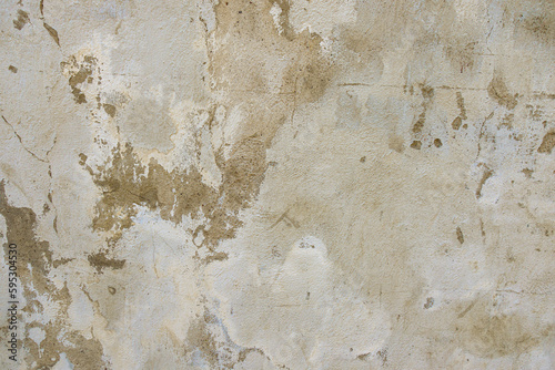 Grey concrete wall background texture. Old grunge uneven surface with scratches and cracks. Rough plaster cement gypsum wall outdoors