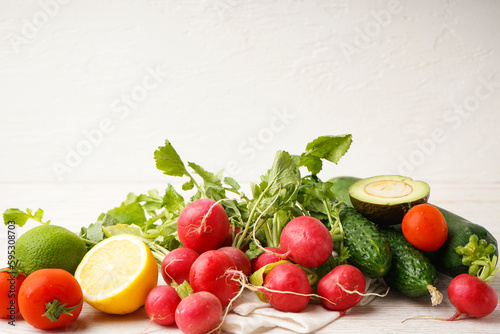 Radish and other spring vegetables on a wooden background  space for text  top view.