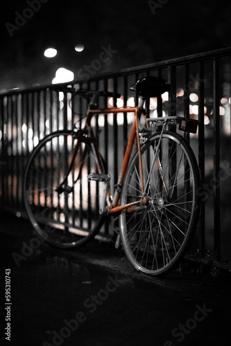 Bike Locked to Fence with Bokeh Balls at Night