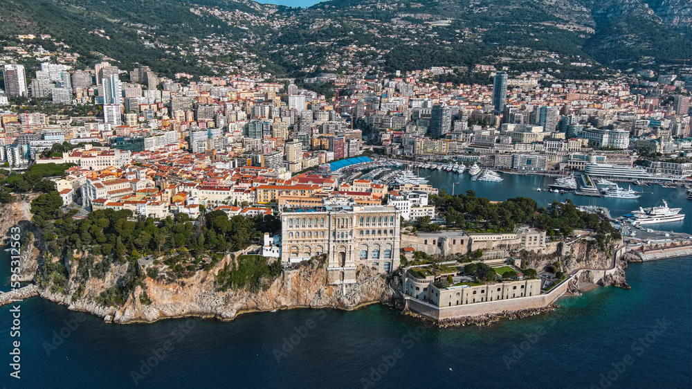 Aerial view of The Oceanographic Museum in Monaco Ville, South France. Prince Palace on the rock in Mediterranean Sea and Old Town around the famous port and marina from above of Monte Carlo 5.5K UHD