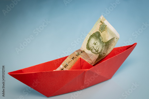 Red paper ship with Chinese yuan, China money, Economic concept, Chinese currency strength, Shipping world markets