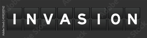 Black color analog flip board with word invasion on gray background