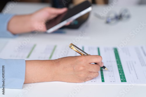 Accountant analyzing business marketing data on paper dashboard Corporate finance office table.  © Tj