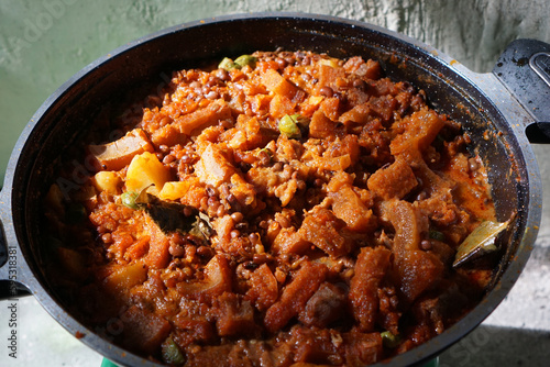 Sambal Goreng Krecek is a side dish to accompany opor or gudeg. It consists of krecek made from beef skin, petai, cowpea beans cooked with coconut milk and chili. Usually served during Eid al-Fitr 