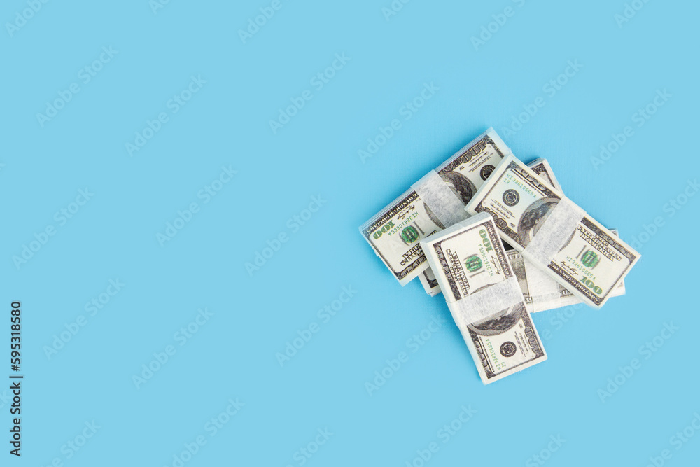 dollar bundles, money cash, currency on a blue background, wealth and income, investment, copy space dollar bundles, money cash, currency on a blue background, wealth and income, investment, copy space