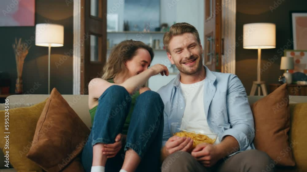 Overjoyed pair laughing comedy watching television pov. Spouses reacting at joke Overjoyed pair laughing comedy watching television pov. Spouses reacting at joke