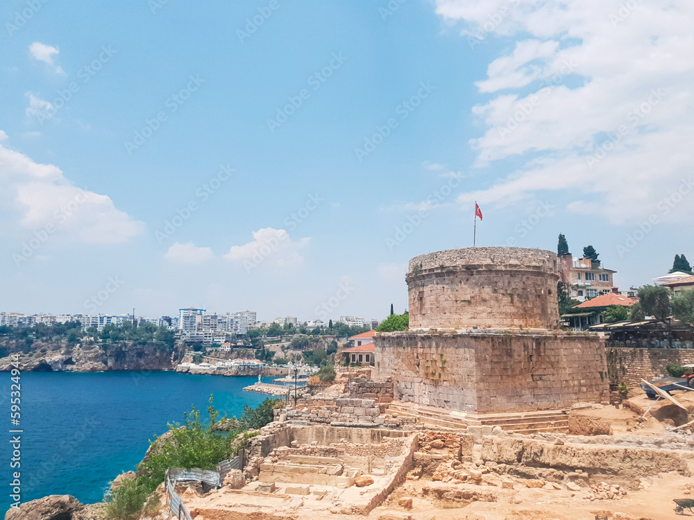 ancient Hidirlik Tower Castle in Kaleici, Antalya, Turkey. Landscape of Antalya old town and Mediterranean sea. ancient Hidirlik Tower Castle in Kaleici, Antalya, Turkey. Landscape of Antalya old town and Mediterranean sea.