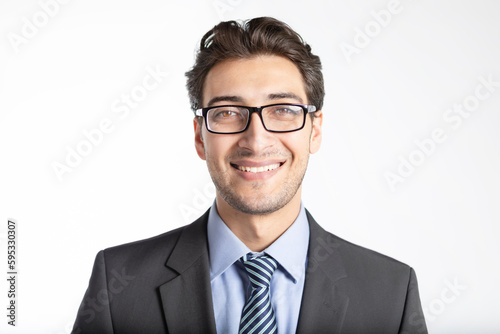 Close-up portrait of handsome smiling businessman in black suit isolated on white background