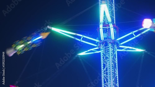 Missiles with people circle around a metal structure at high altitude. lots of lights  