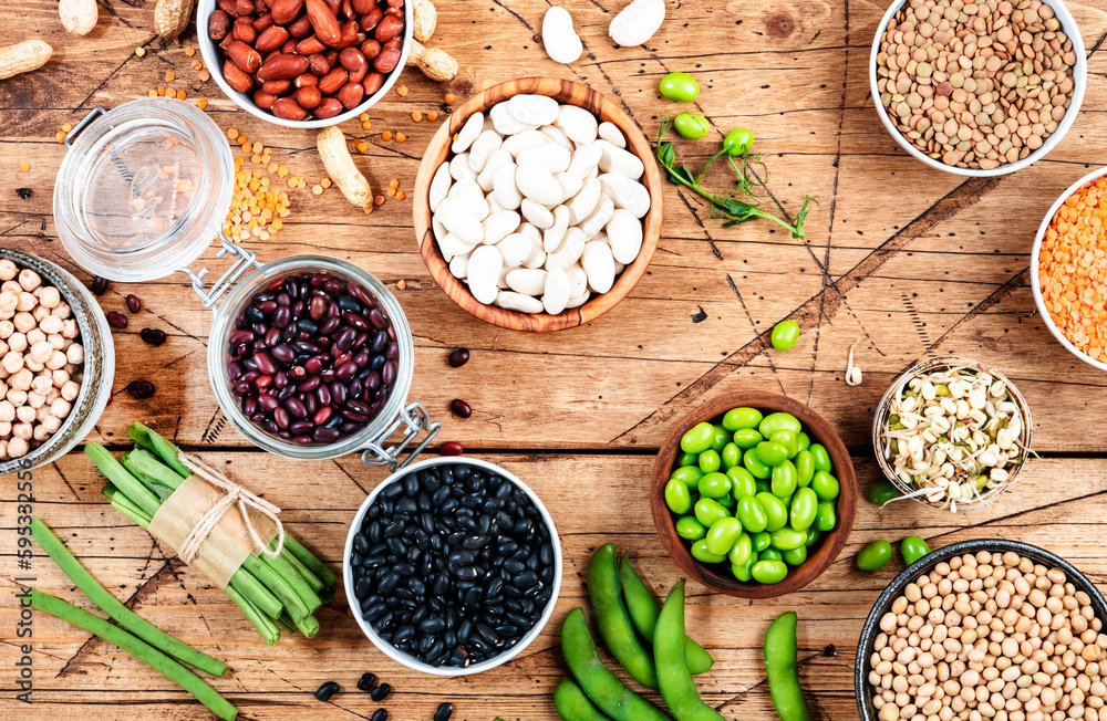 Legumes, beans and sprouts. Dried, raw and fresh, top view. Lentils, mung beans, chickpeas, soybeans, edamame, peas, Healthy diet food, vegan proetin, micronutrients and fiber sources, top view