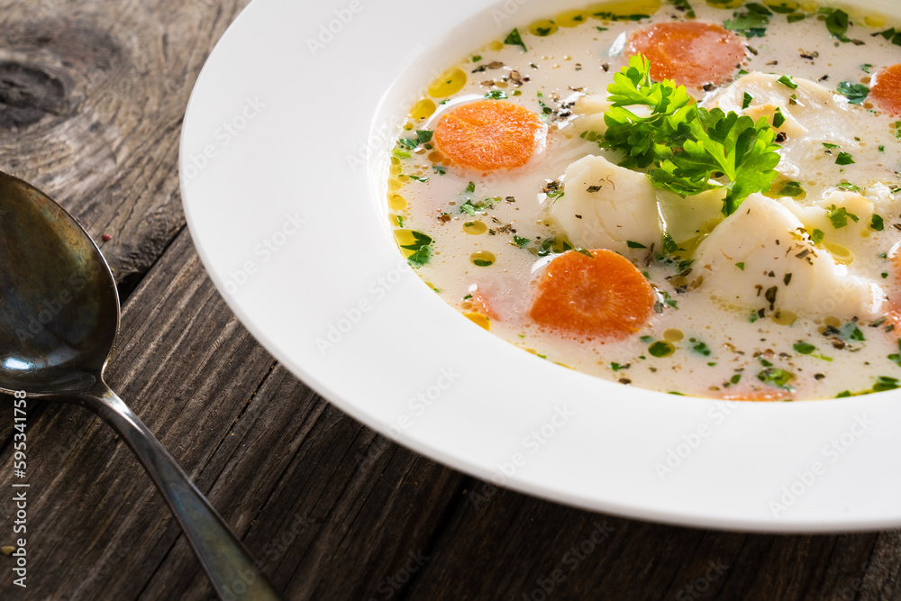 Fish soup on wooden table
