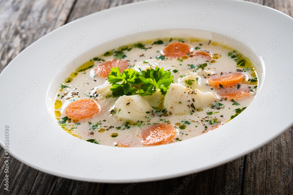 Fish soup on wooden table
