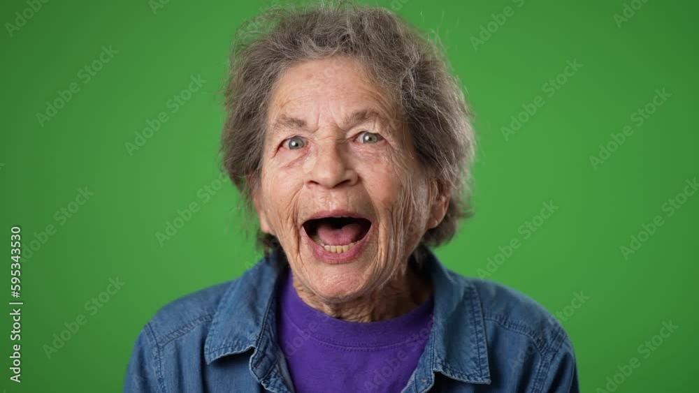 Closeup slow motion portrait of happy smiling excited elderly senior old woman nod head yes, with wrinkled skin and grey hair on green screen background. Closeup slow motion portrait of happy smiling excited elderly senior old woman nod head yes, with wrinkled skin and grey hair on green screen background.